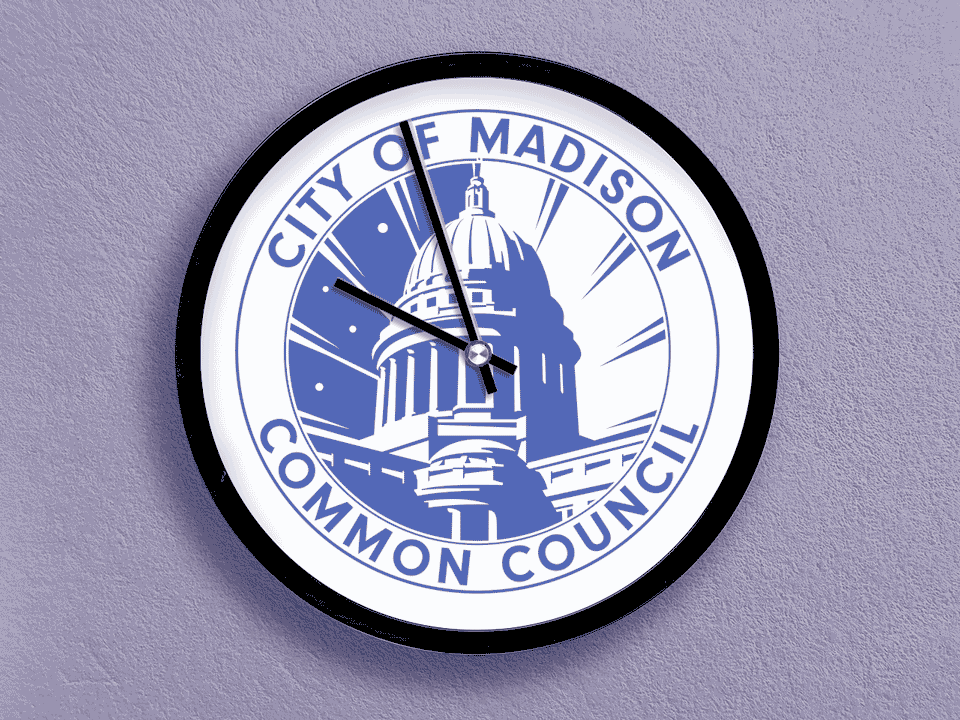 A time lapse of a clock with the City of Madison Common Council logo on it.