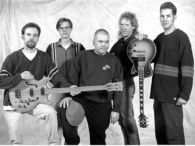 A black and white photo of the five-member group Marques Bovre and the Evil Twins taken in 2000.