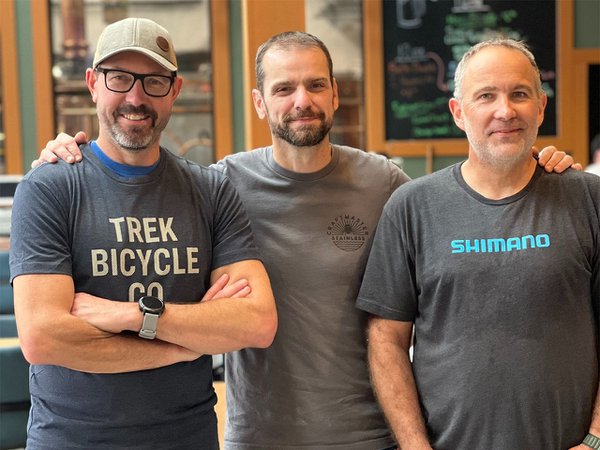 Three men in gray t-shirts.