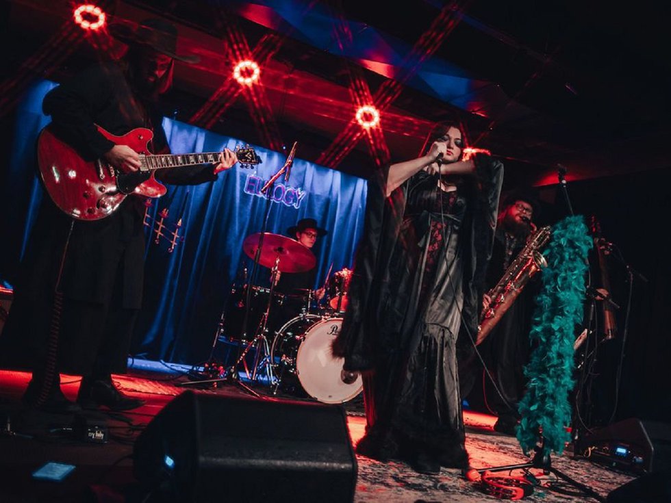Adrianne Blanks and the Oracles on stage.