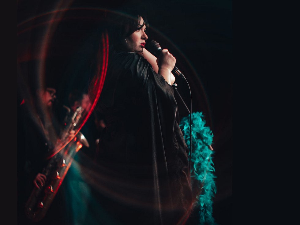 Adrianne Blanks and the Oracles on stage.