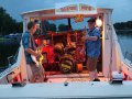 The Broken Boards playing on a boat.