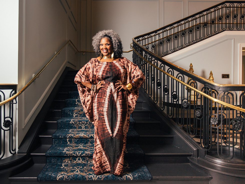 Angela Brown in front of a staircase.