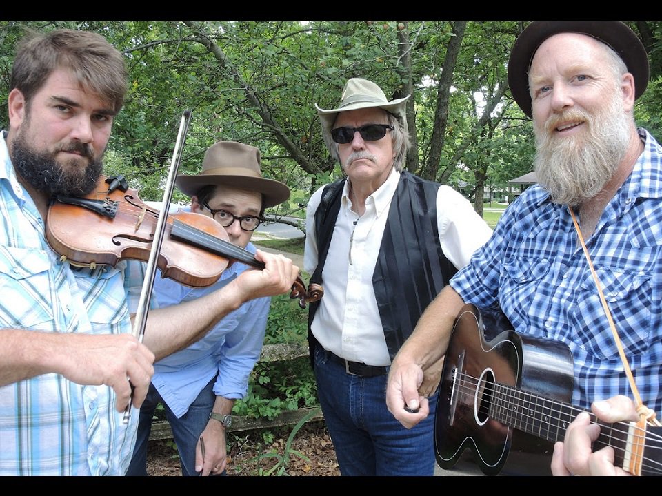 The Cajun Strangers and instruments.