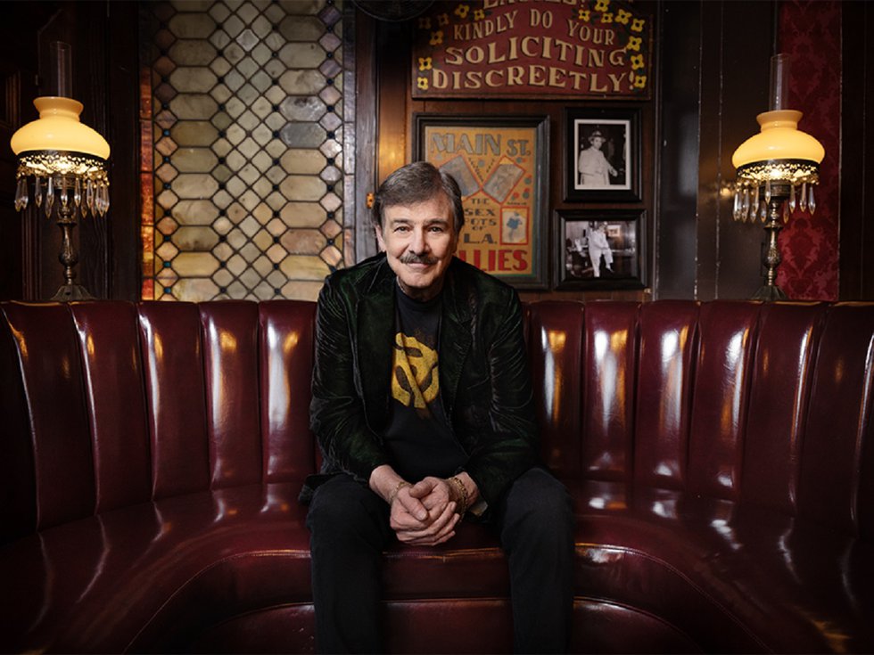 Burton Cummings sitting on a bench.