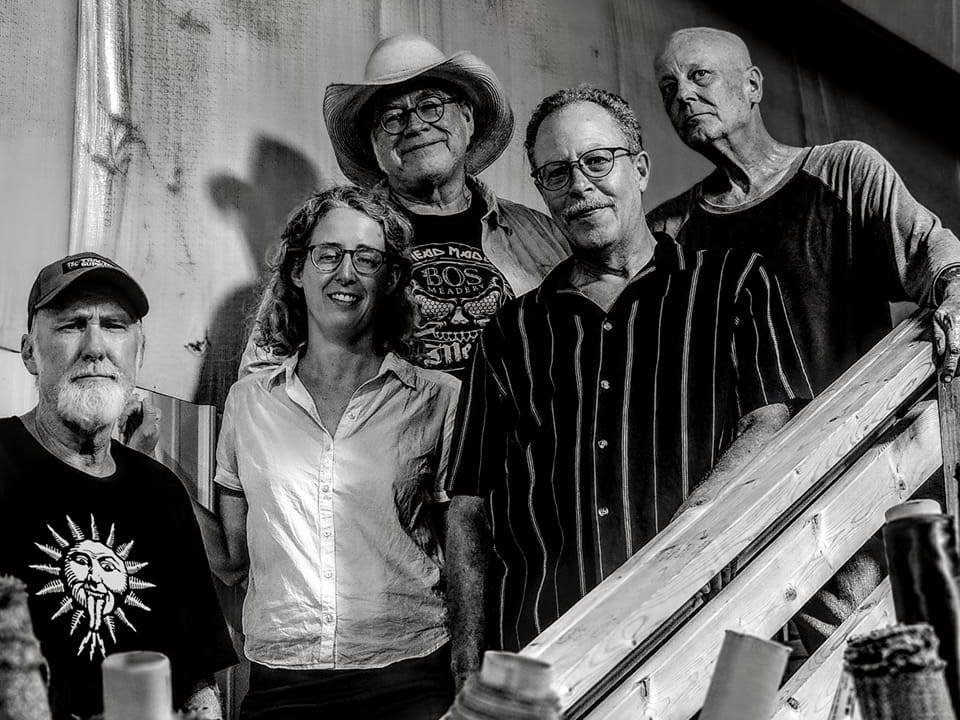 The five members of Dry River Goats on a staircase.