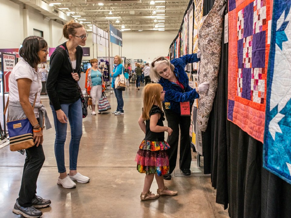 A child learns about quilts.