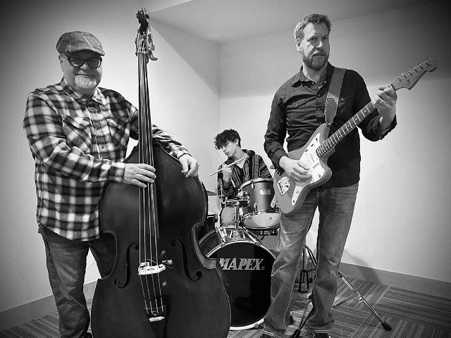Three people and musical instruments.