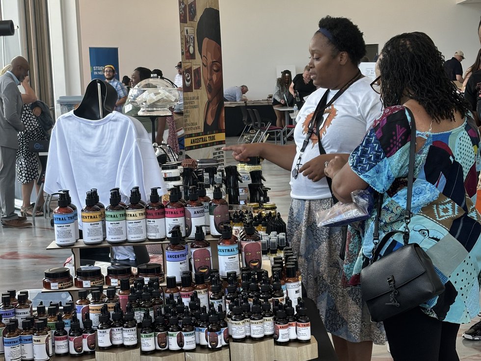 Shoppers and a display at a past Hub Marketplace.