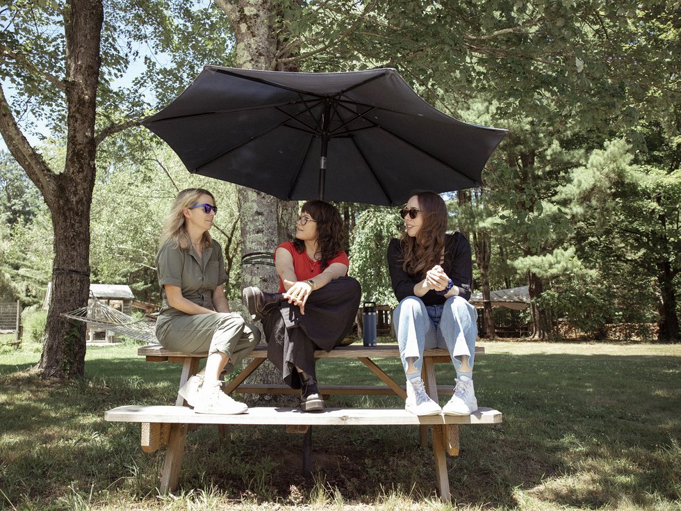 I'm With Her sitting on a picnic table.
