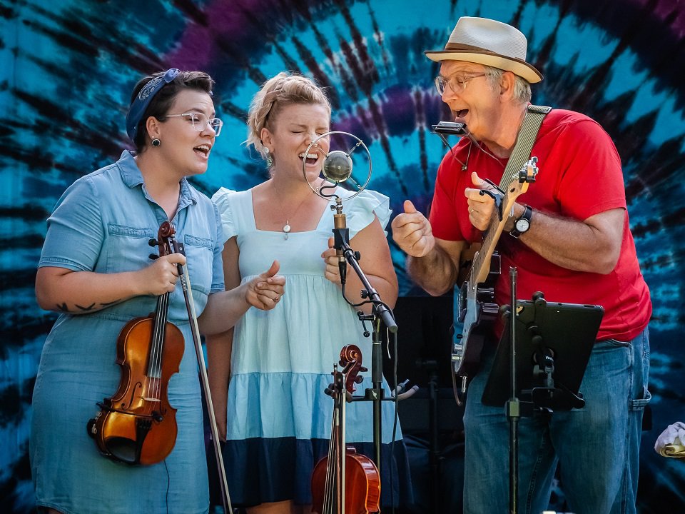 Krause Family Band around a mic.