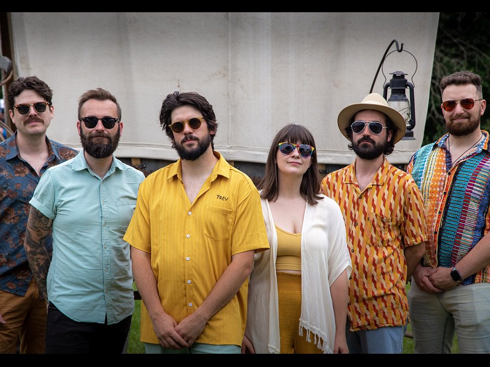 The six-piece band Marigold Motel poses for a photo.