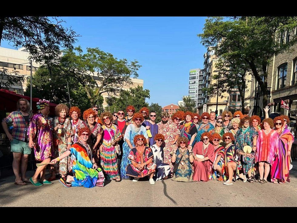 A group of people in colorful dresses on King Street.