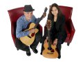 Red Door members Dave Irwin (left) and Helen Avakian with guitars on chairs.