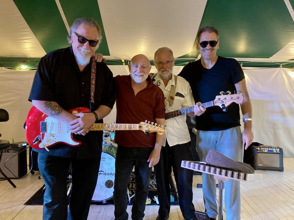 Reverend Raven and the Chain Smokin' Altar Boys pause for a photo on stage.