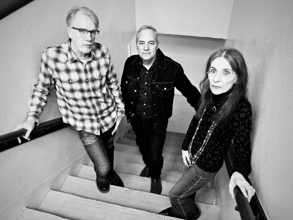 The three members of the band Swarme of Beese in a stairwell.