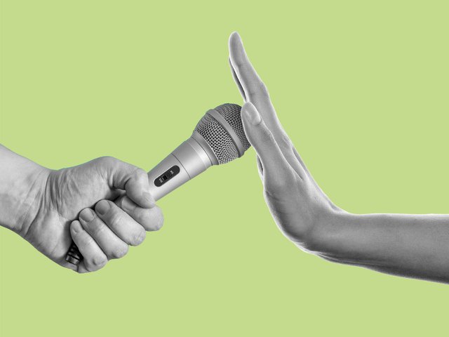 A hand covering up a microphone.