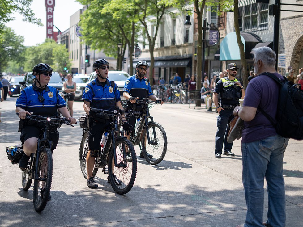 A protester talks to bike cops at the No Kings protest on June 14, 2025.