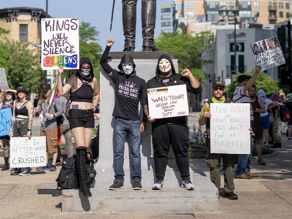 Protestors donning Guy Fawkes masks at the No Kings protest on June 14, 2025.