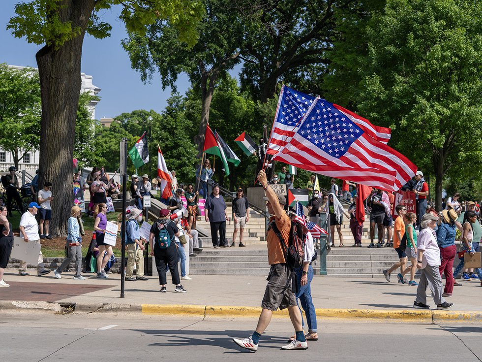 Protestors holding American and Palestinian flags at the No Kings protest on June 14, 2025.