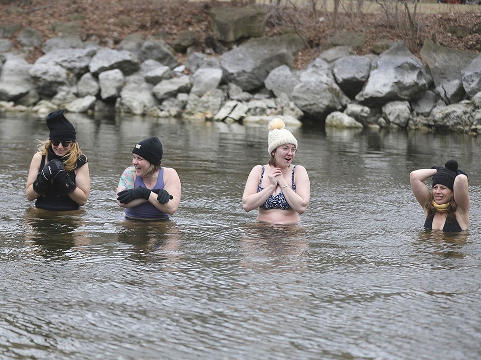 The Foxie Dippers submerge into the Yahara River.