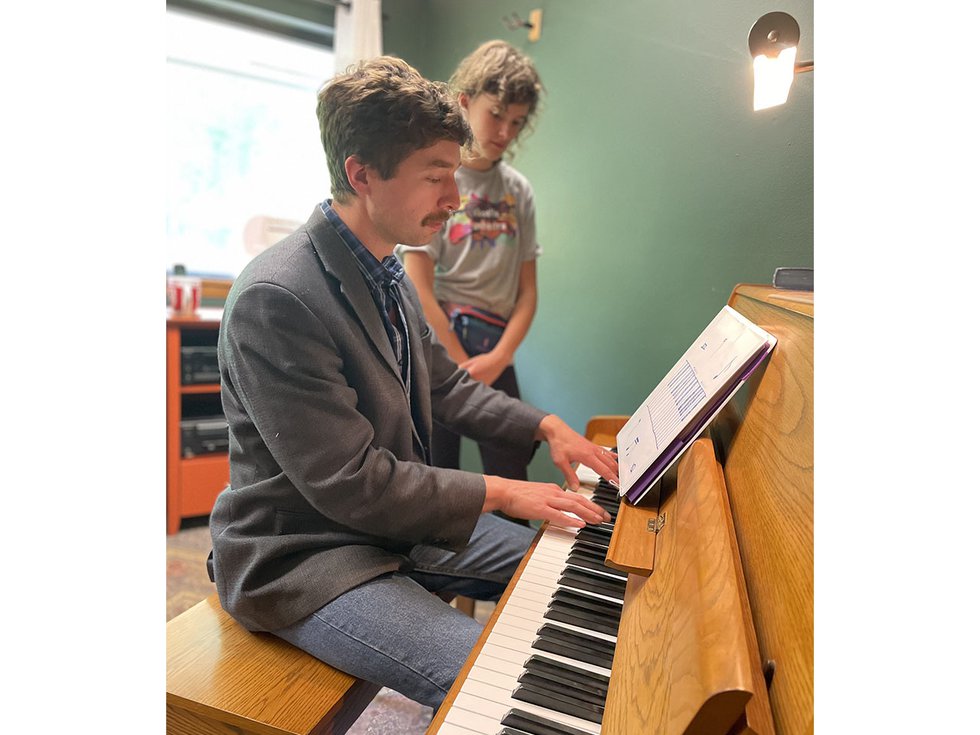 Wilder Deitz giving a piano lesson to a student.